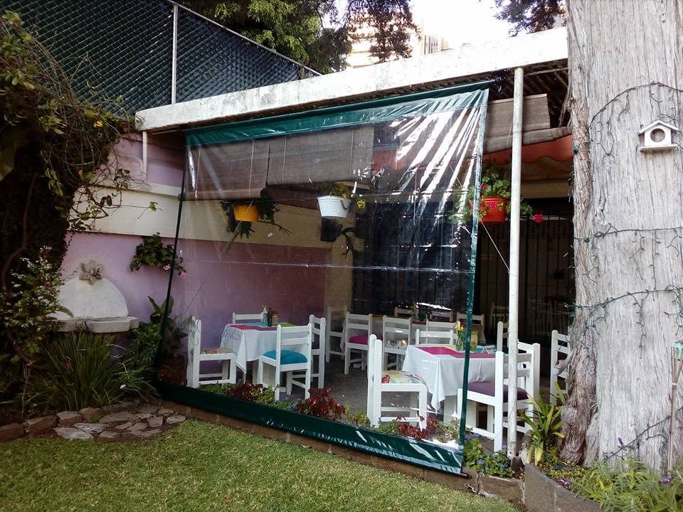Terraza cubierta con toldo y cortinas transparentes