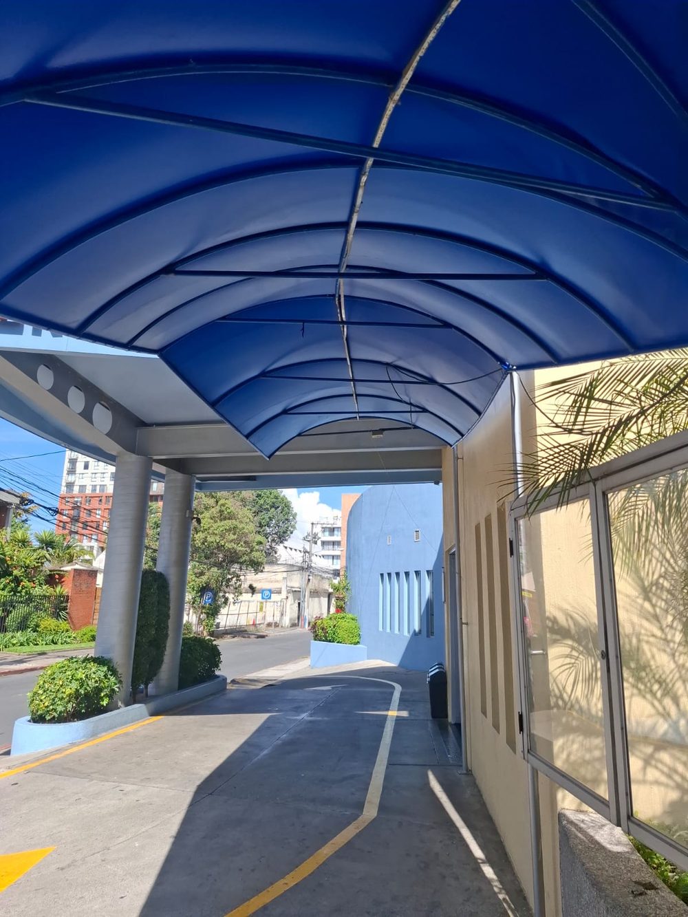 Cubierta curva de lona azul sobre la entrada de un edificio