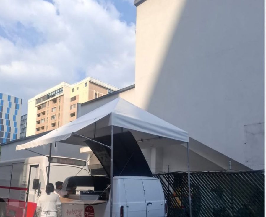 Toldo desmontable con cenefa expandible junto a un food truck